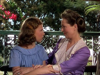 Movie still from “The River” (1951), directed by Jean Renoir – A woman and a young girl standing next to each other; Medium shot, Over the shoulder angle