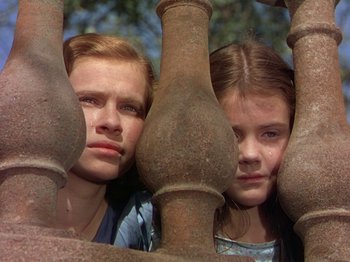 Movie still from “The River” (1951), directed by Jean Renoir – Two young girls are looking over a railing; Close Up shot, Low angle