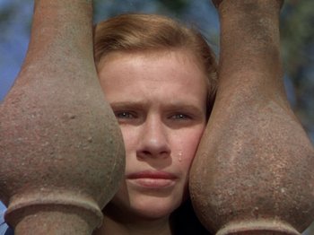 Movie still from “The River” (1951), directed by Jean Renoir – A young man is hiding his face with his hands; Close Up shot, High angle
