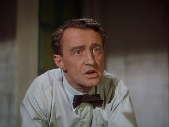Movie still from “The River” (1951), directed by Jean Renoir – An older man wearing a white shirt and a bow tie; Close Up shot, High angle