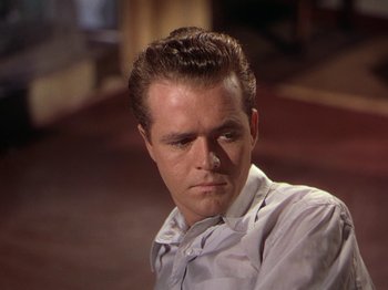 Movie still from “The River” (1951), directed by Jean Renoir – A person wearing a dress shirt; Close Up shot, Over the shoulder angle