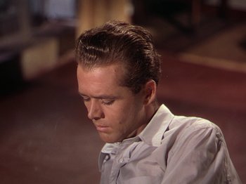 Movie still from “The River” (1951), directed by Jean Renoir – A person wearing a dress shirt; Close Up shot, High angle