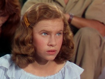 Movie still from “The River” (1951), directed by Jean Renoir – A young girl with a blue eyes and red hair; Close Up shot, High angle