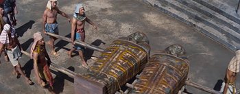 Movie still from “The Robe” (1953), directed by Henry Koster – A man is walking on the ground near a pile of wood; Wide shot, Overhead angle