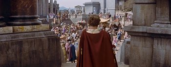 Movie still from “The Robe” (1953), directed by Henry Koster – A crowd of people walking down a street; Extreme Wide shot, High angle