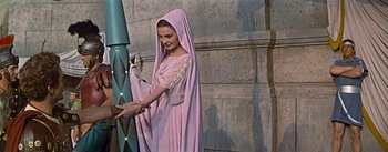 Movie still from “The Robe” (1953), directed by Henry Koster – A woman dressed in roman clothing holding a sword; Medium shot, Low angle
