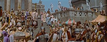 Movie still from “The Robe” (1953), directed by Henry Koster – A group of people standing on a set of stairs; Wide shot, High angle