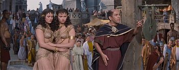 Movie still from “The Robe” (1953), directed by Henry Koster – A group of people in costumes walking in a crowd; Medium shot, Low angle