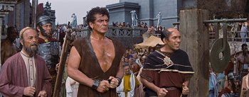 Movie still from “The Robe” (1953), directed by Henry Koster – Two men in ancient roman garb in front of a crowd of onlookers; Medium shot, Low angle