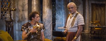 Movie still from “The Robe” (1953), directed by Henry Koster – Two men dressed as roman soldiers are standing next to each other; Medium shot, Over the shoulder angle