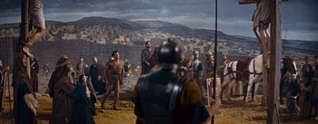 Movie still from “The Robe” (1953), directed by Henry Koster – A group of men standing around in front of a building; Wide shot, High angle