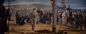 Movie still from “The Robe” (1953), directed by Henry Koster – A group of people standing in a dirt field; Wide shot, Low angle