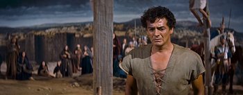 Movie still from “The Robe” (1953), directed by Henry Koster – A person wearing a shirt; Medium shot, Over the shoulder angle