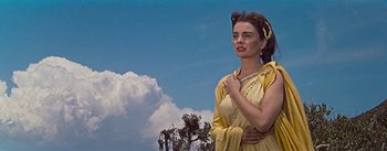 Movie still from “The Robe” (1953), directed by Henry Koster – A woman dressed in a roman costume with her hands on her chest; Medium shot, Low angle