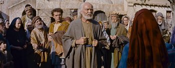 Movie still from “The Robe” (1953), directed by Henry Koster – An old man with a beard and a long white beard standing in front of a group of men; Medium shot, Low angle