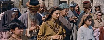 Movie still from “The Robe” (1953), directed by Henry Koster – A group of men and women standing next to each other; Medium shot, High angle