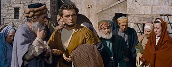 Movie still from “The Robe” (1953), directed by Henry Koster – A group of men standing next to each other; Medium shot, Low angle