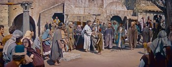 Movie still from “The Robe” (1953), directed by Henry Koster – A painting of a group of people walking in the street; Wide shot, High angle