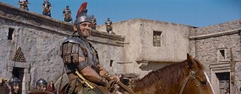 Movie still from “The Robe” (1953), directed by Henry Koster – A man in a roman soldier's outfit riding a horse; Medium shot, Low angle