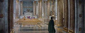 Movie still from “The Robe” (1953), directed by Henry Koster – A man dressed as a roman emperor stands in front of a statue; Extreme Wide shot, High angle