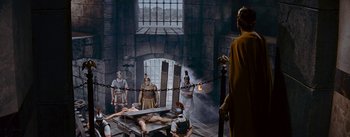 Movie still from “The Robe” (1953), directed by Henry Koster – A group of people standing in a room; Wide shot, High angle