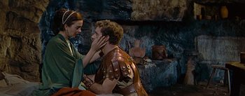 Movie still from “The Robe” (1953), directed by Henry Koster – A man in a leather jacket is touching a woman's face; Medium shot, Over the shoulder angle