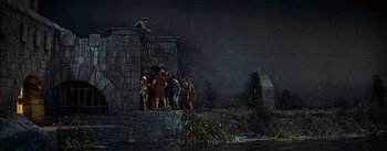 Movie still from “The Robe” (1953), directed by Henry Koster – A group of people standing on top of a stone wall; Extreme Wide shot, High angle