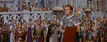 Movie still from “The Robe” (1953), directed by Henry Koster – A group of men in roman garb in front of a crowd; Medium shot, Low angle