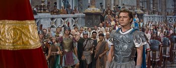 Movie still from “The Robe” (1953), directed by Henry Koster – A group of people in roman garb standing in front of a crowd; Medium shot, Low angle