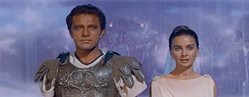 Movie still from “The Robe” (1953), directed by Henry Koster – A man and a woman dressed in roman garb in front of a painting; Medium shot, Low angle