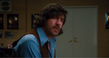 Movie still from “The Rose” (1979), directed by Mark Rydell – A person with long hair; Close Up shot, Over the shoulder angle