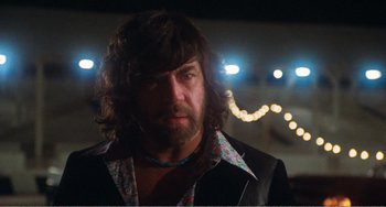 Movie still from “The Rose” (1979), directed by Mark Rydell – A person with long hair and a beard; Close Up shot, Low angle