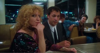 Movie still from “The Rose” (1979), directed by Mark Rydell – A man and a woman are sitting at a table; Medium shot, Over the shoulder angle