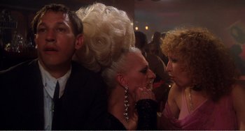 Movie still from “The Rose” (1979), directed by Mark Rydell – A group of people sitting around a room together; Close Up shot, Over the shoulder angle