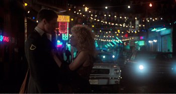 Movie still from “The Rose” (1979), directed by Mark Rydell – A man and a woman standing next to each other on the street; Wide shot, Low angle