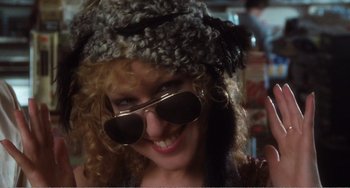 Movie still from “The Rose” (1979), directed by Mark Rydell – A person wearing sunglasses and a hat; Close Up shot, Low angle