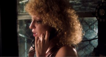 Movie still from “The Rose” (1979), directed by Mark Rydell – A person talking on a cell phone; Close Up shot, Low angle