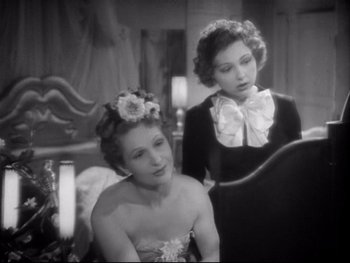 Movie still from “The Rules of the Game” (1939), directed by Jean Renoir – Two beautiful women sitting next to each other in a room; Medium shot, Over the shoulder angle