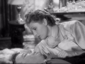 Movie still from “The Rules of the Game” (1939), directed by Jean Renoir – An old black and white photo of a man and a woman; Close Up shot, High angle