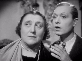 Movie still from “The Rules of the Game” (1939), directed by Jean Renoir – A woman and a man are standing next to each other; Close Up shot, Low angle