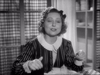 Movie still from “The Rules of the Game” (1939), directed by Jean Renoir – An older woman sitting at a table in a room; Medium shot, High angle