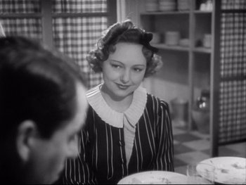 Movie still from “The Rules of the Game” (1939), directed by Jean Renoir – An old photo of a woman sitting at a dinner table; Close Up shot, Over the shoulder angle