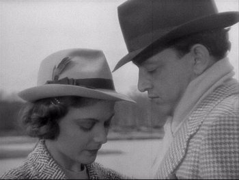 Movie still from “The Rules of the Game” (1939), directed by Jean Renoir – A man and a woman wearing cowboy hats; Close Up shot, Low angle