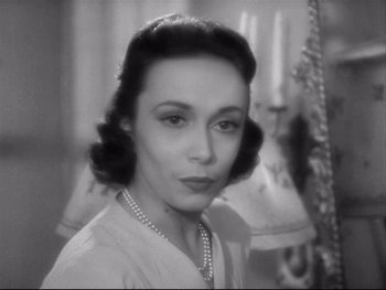 Movie still from “The Rules of the Game” (1939), directed by Jean Renoir – An old photo of an older woman with a necklace; Close Up shot, High angle