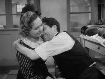 Movie still from “The Rules of the Game” (1939), directed by Jean Renoir – A man and a woman embracing each other in front of a mirror; Medium shot, High angle