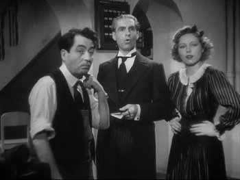 Movie still from “The Rules of the Game” (1939), directed by Jean Renoir – A group of people standing next to each other in a room; Medium shot, Low angle