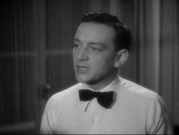Movie still from “The Rules of the Game” (1939), directed by Jean Renoir – A man wearing a white shirt and a black bow tie; Close Up shot, Low angle