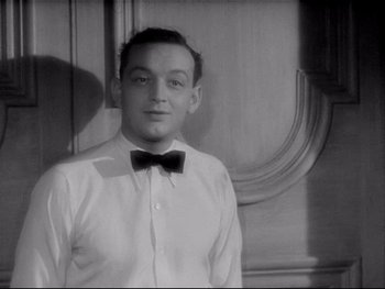 Movie still from “The Rules of the Game” (1939), directed by Jean Renoir – A man in a white shirt and a black bow tie; Close Up shot, Low angle