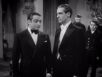 Movie still from “The Rules of the Game” (1939), directed by Jean Renoir – Two men in tuxedos standing next to each other; Medium shot, High angle