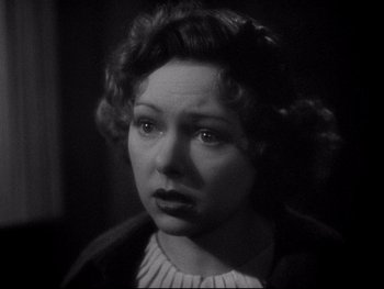 Movie still from “The Rules of the Game” (1939), directed by Jean Renoir – An old photo of a woman looking at the camera; Close Up shot, High angle